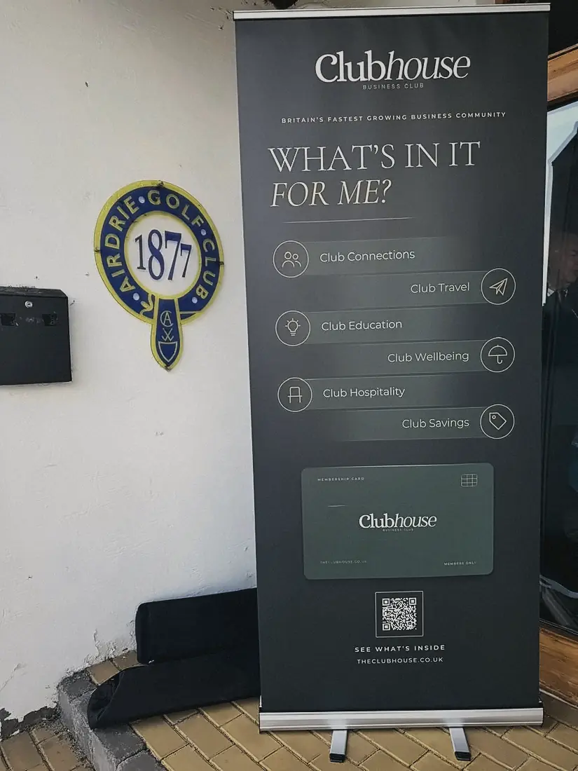 The Clubhouse banner beside the Airdrie Golf Club crest